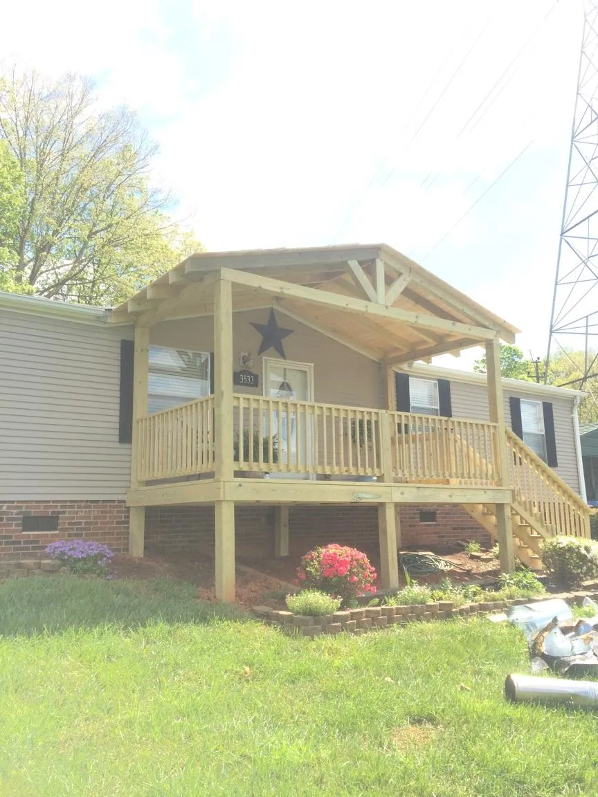 New gabled porch roof and deck railing added to a ranch home in College Park